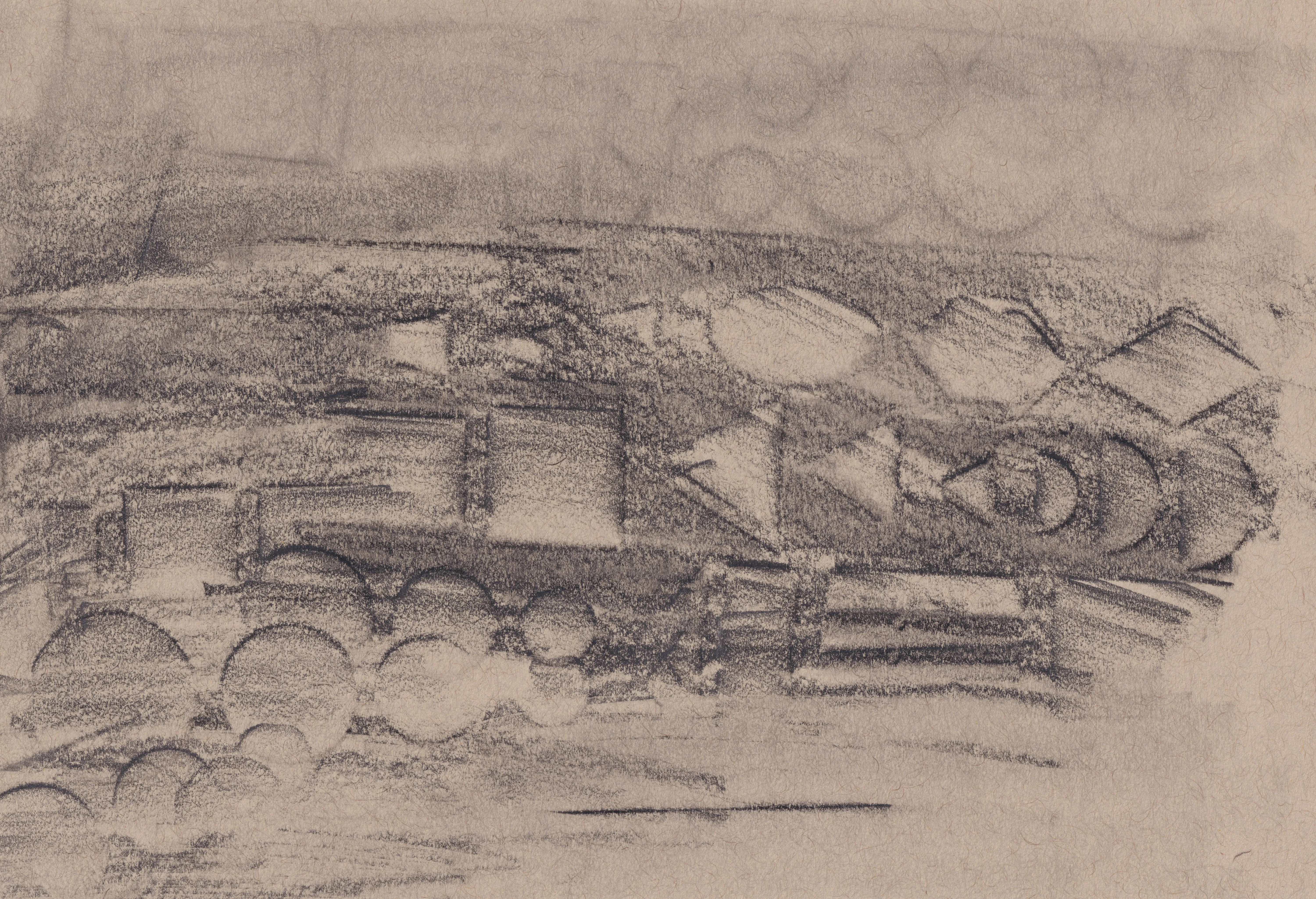 Charcoal rubbing on brown paper: a band of blocks, triangles and half-circles running across the sheet like a frieze