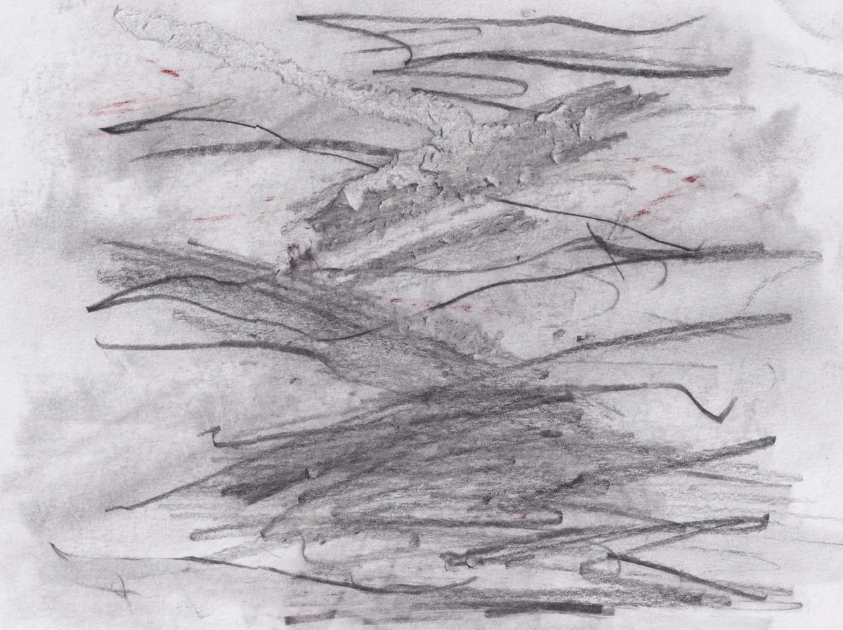 Dense horizontal graphite scribbles over a grey wash on white paper, with a few small red marks