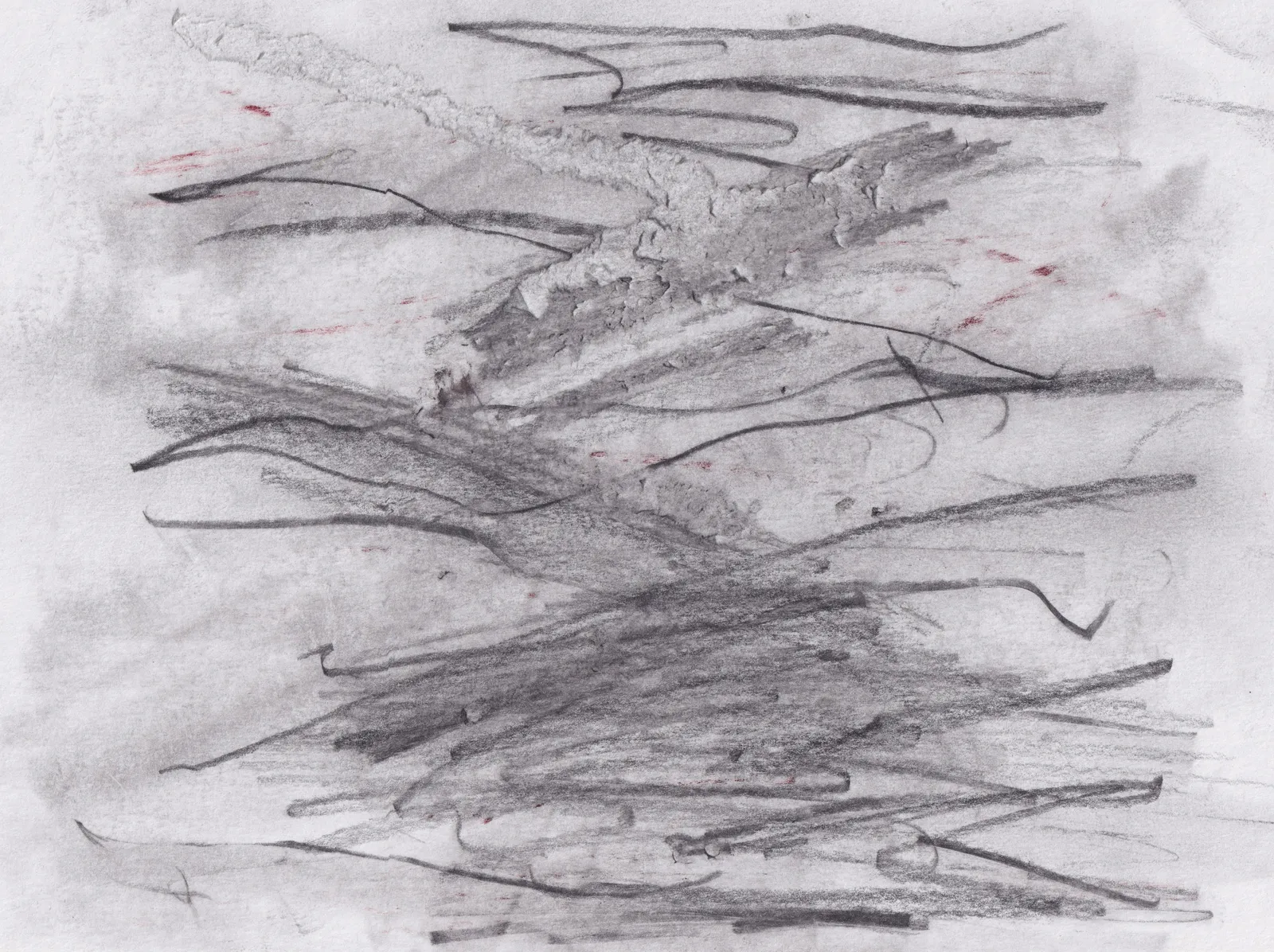 Dense horizontal graphite scribbles over a grey wash on white paper, with a few small red marks