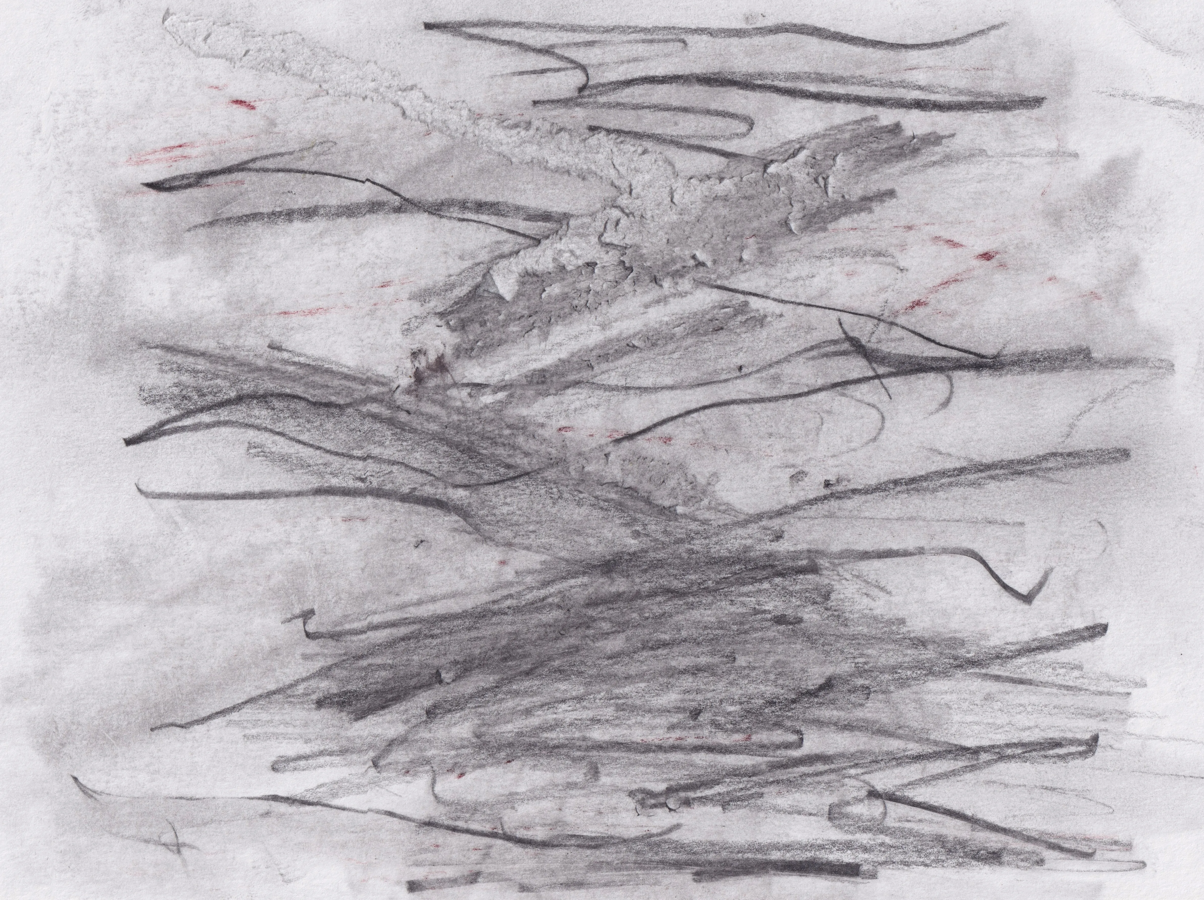 Dense horizontal graphite scribbles over a grey wash on white paper, with a few small red marks