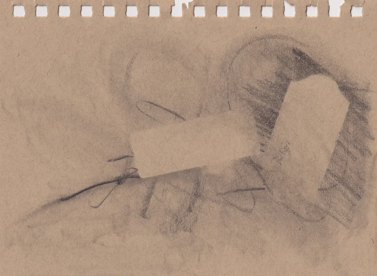 Pencil drawing on a brown sketchbook page: two bare blocks of paper left clear among soft shading and hatching, with a few dark looping lines and torn spiral-binding holes along the top edge