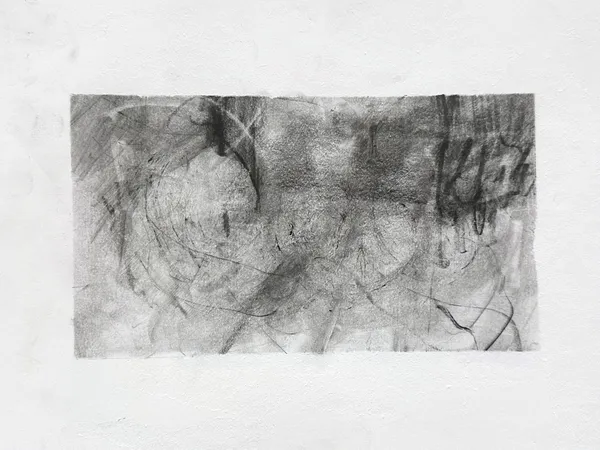 Wide graphite drawing on white paper: a smoky grey ground of looping ovals and scratched lines, darkest across the top, with dense dripping vertical strokes at the right