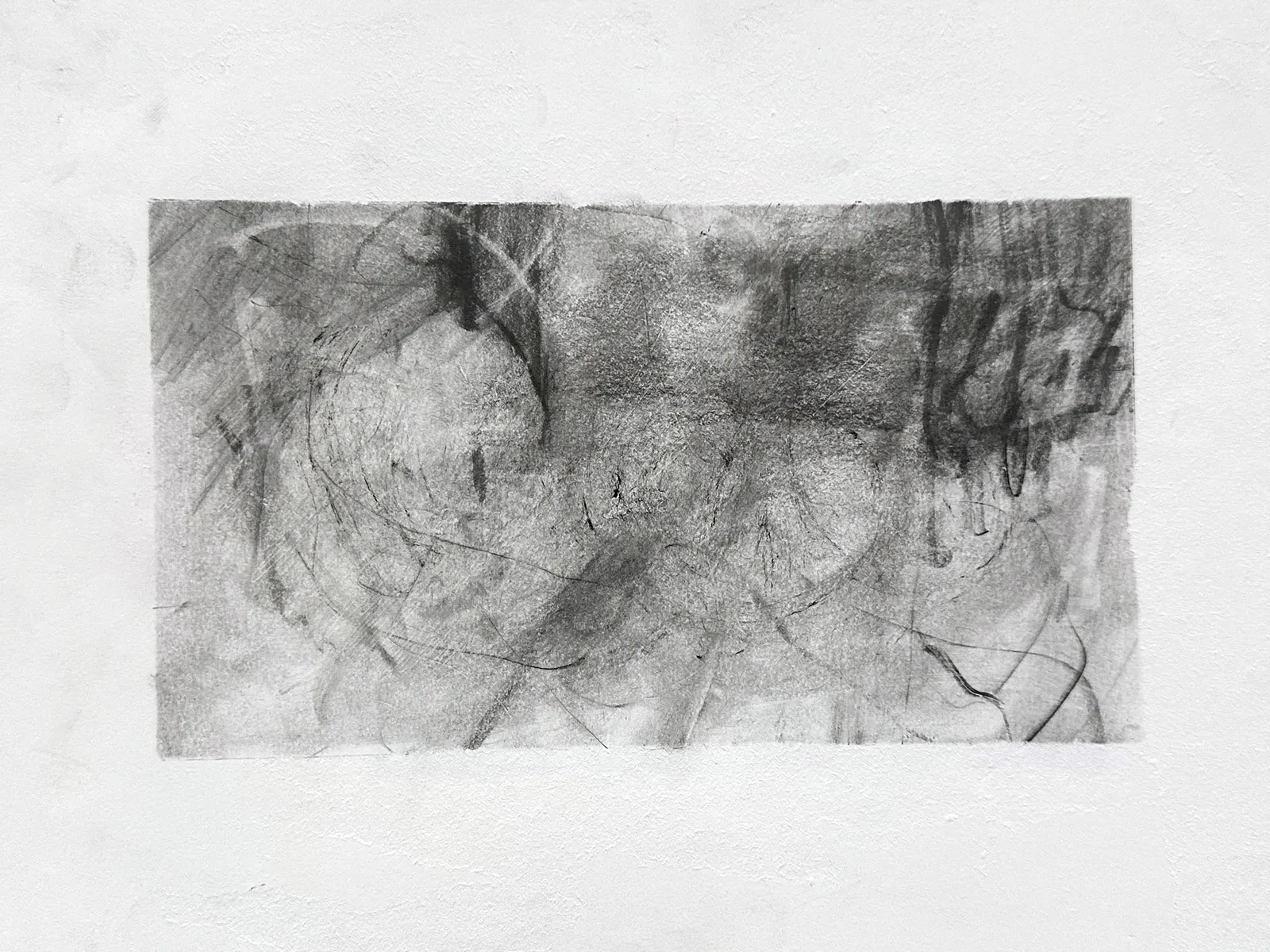 Wide graphite drawing on white paper: a smoky grey ground of looping ovals and scratched lines, darkest across the top, with dense dripping vertical strokes at the right