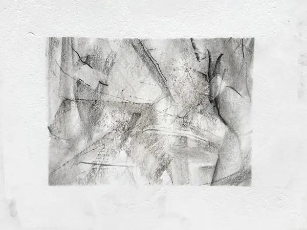 Wide graphite drawing on white paper: overlapping smudged planes crossed by sharp diagonal lines, with dark curved strokes like wings along the right side